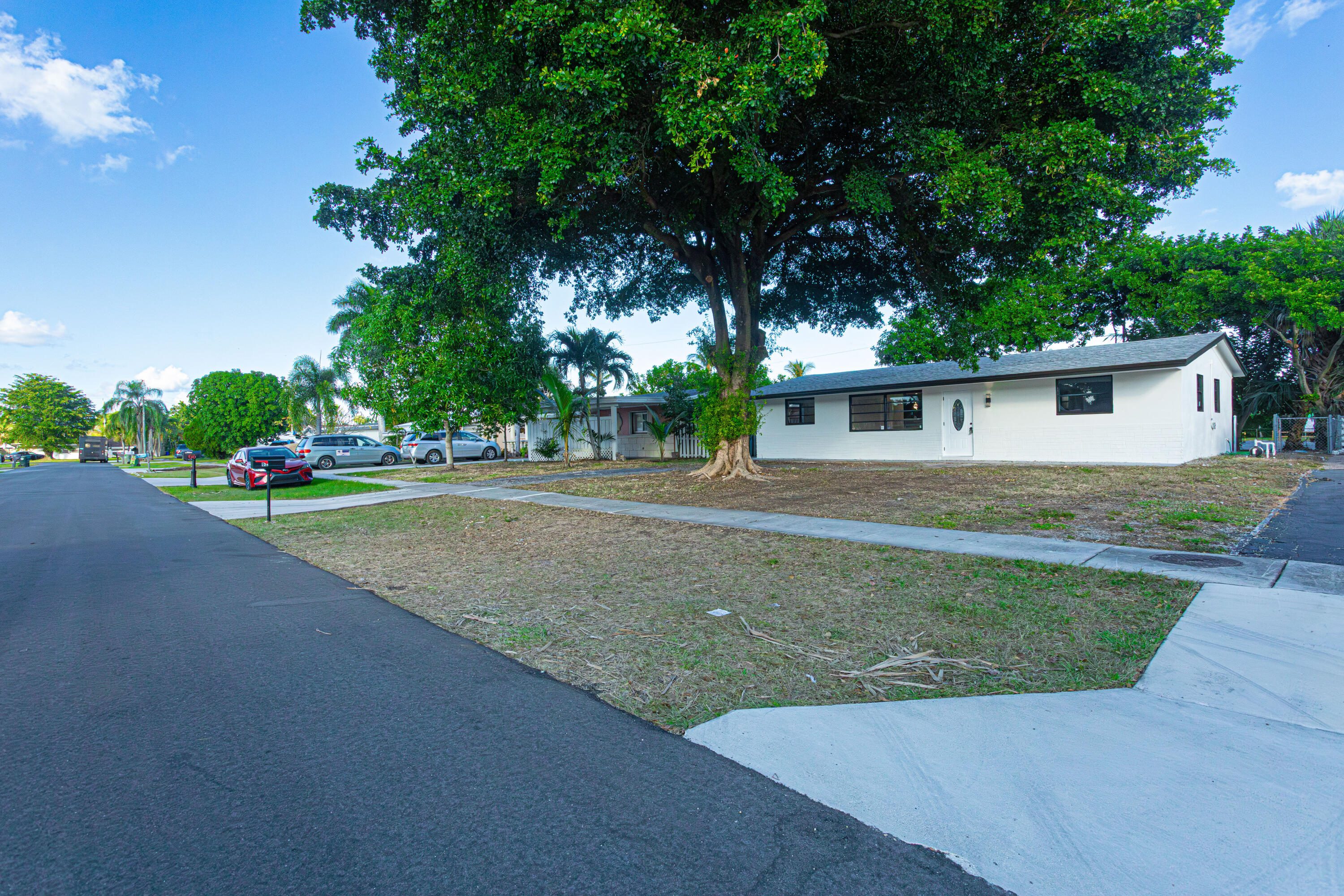 62 Andros Road Palm Springs, FL 33461 - Photo 1 of 41 a view of a house with a yard and tree s