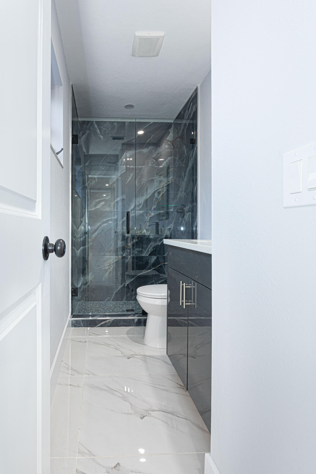 62 Andros Road Palm Springs, FL 33461 - Photo 18 of 41 a bathroom with a shower and a toilet