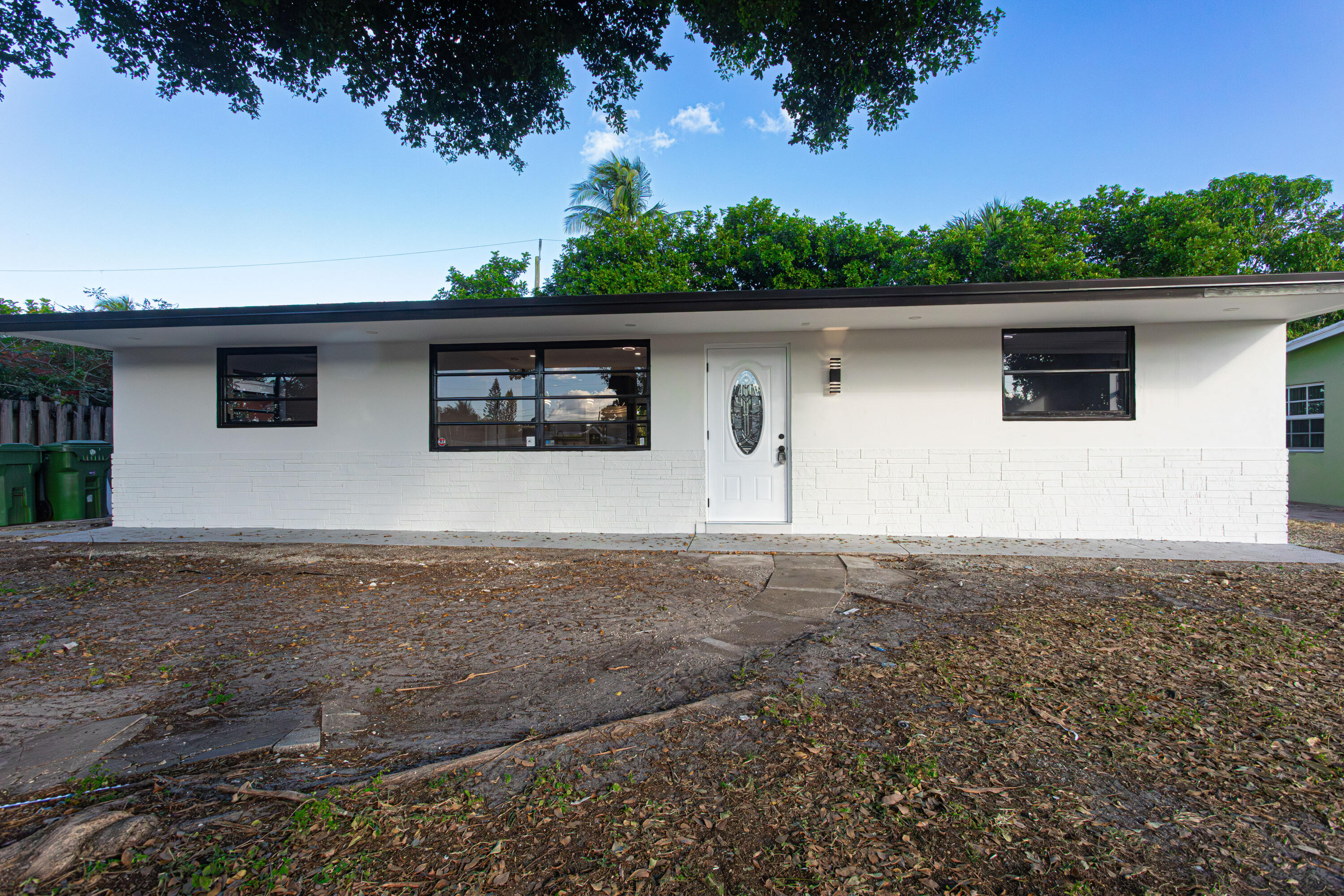 62 Andros Road Palm Springs, FL 33461 - Photo 2 of 41 a house view with a garden space