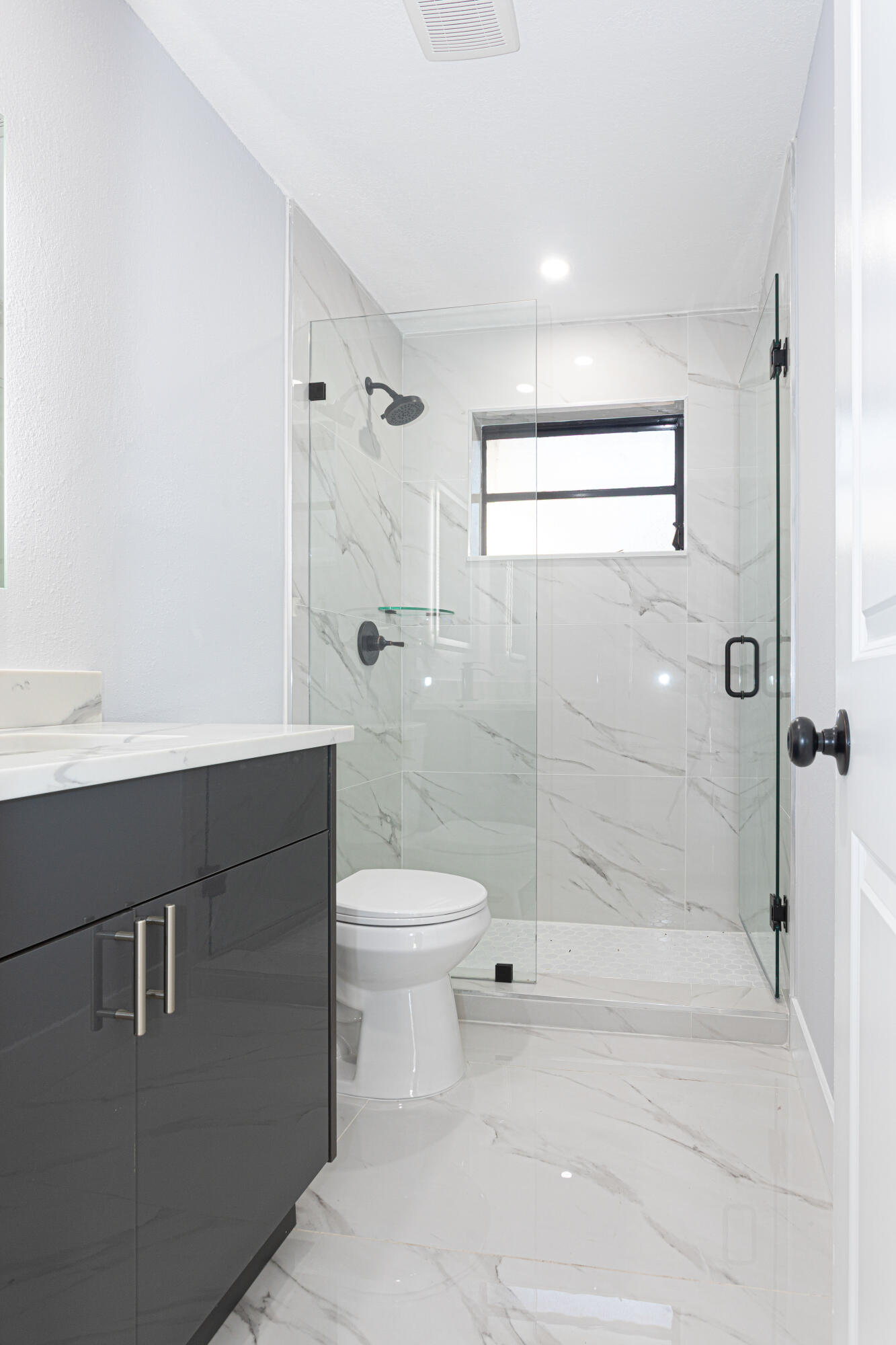 62 Andros Road Palm Springs, FL 33461 - Photo 25 of 41 a bathroom with a sink a toilet and shower