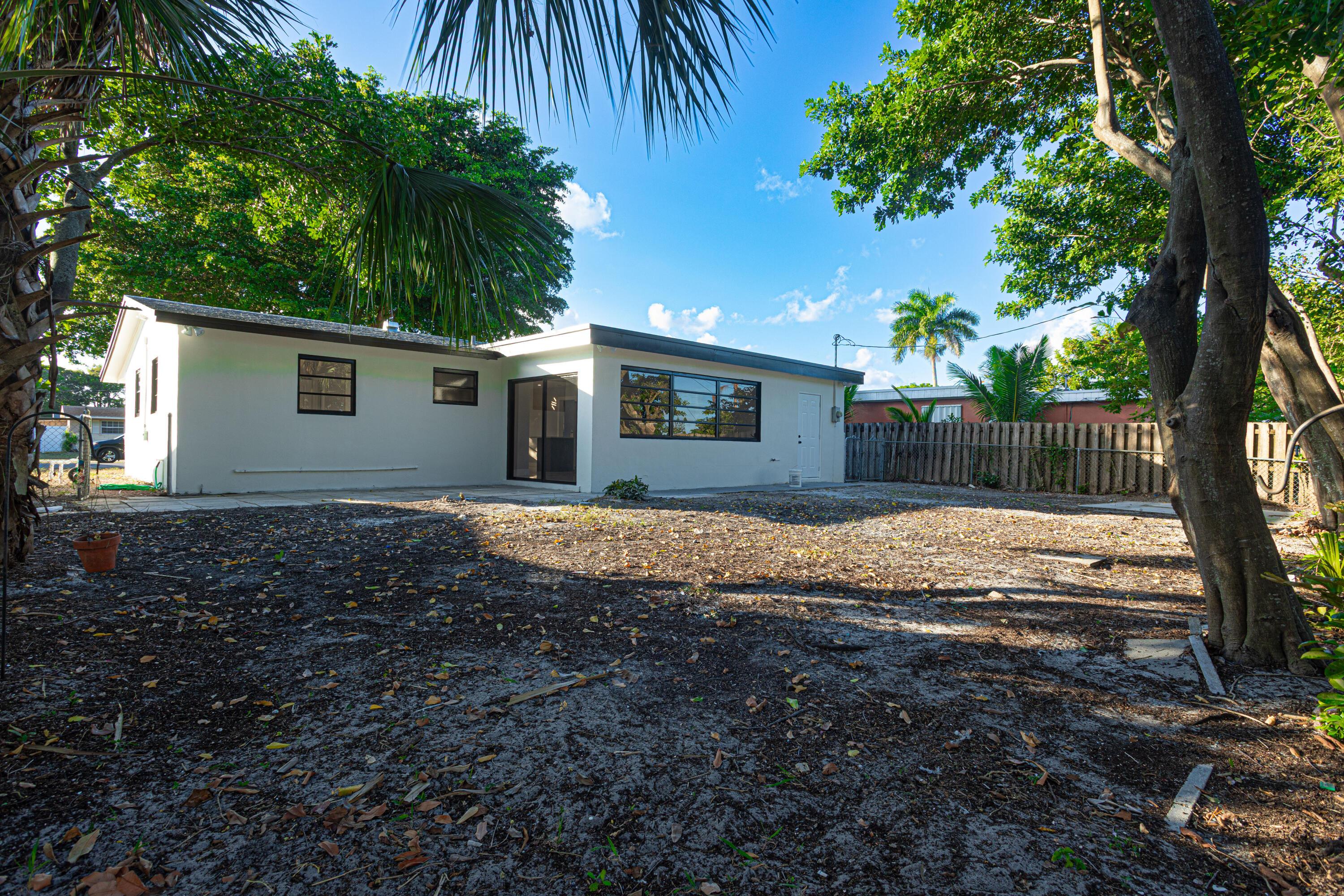 62 Andros Road Palm Springs, FL 33461 - Photo 27 of 41 a view of a backyard with plants and large trees