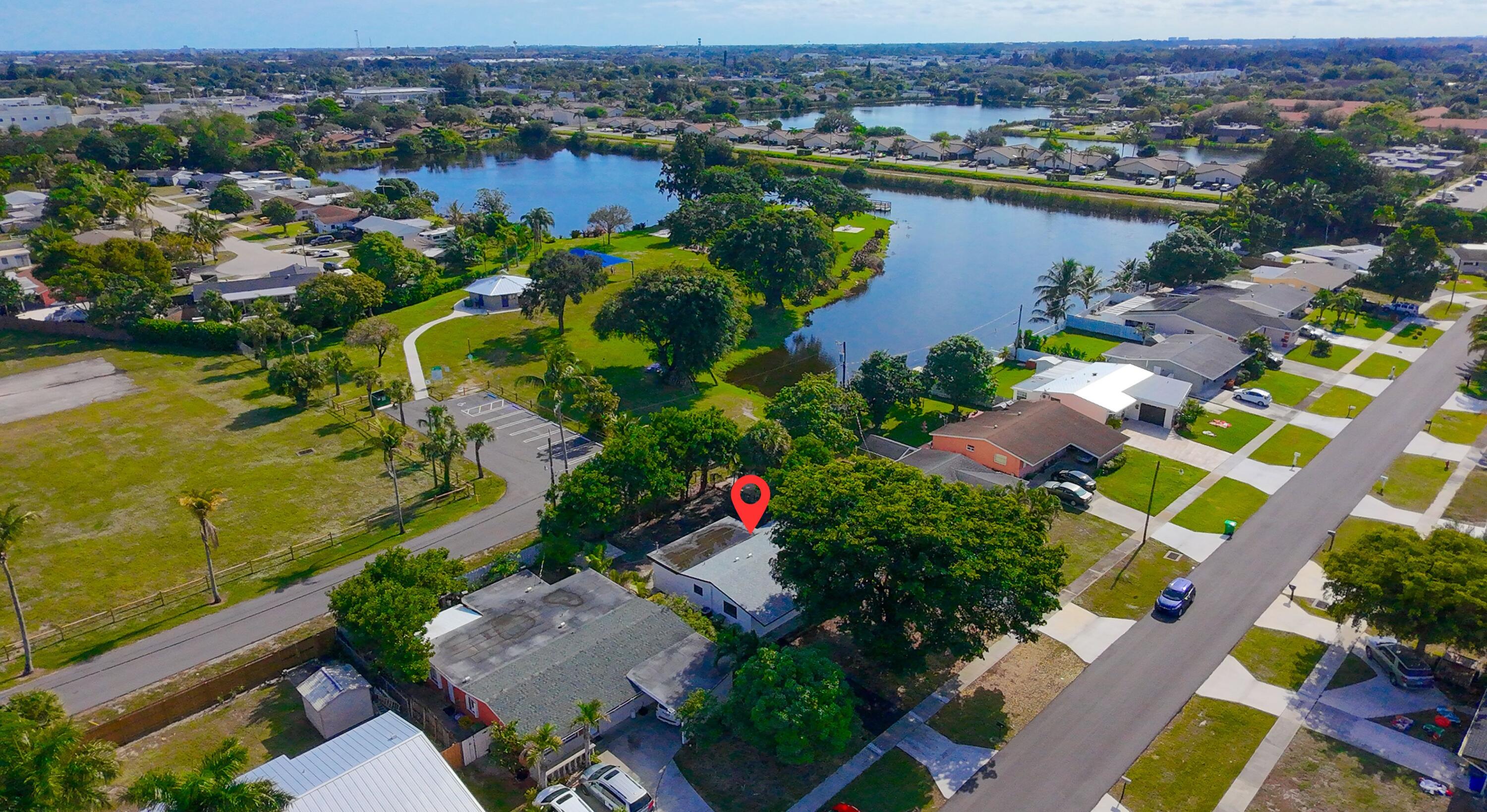 62 Andros Road Palm Springs, FL 33461 - Photo 31 of 41 an aerial view of lake and residential houses with outdoor space