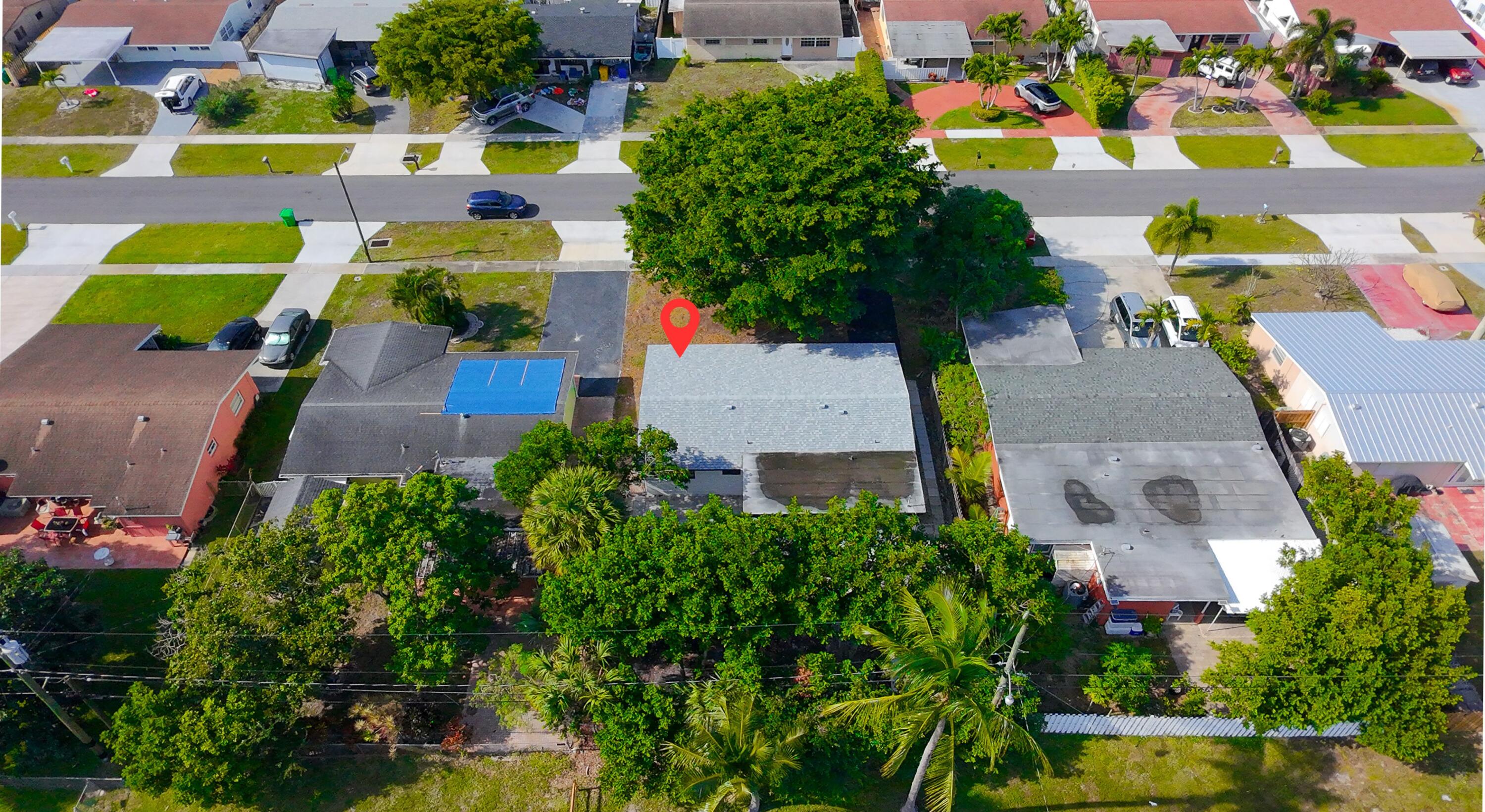 62 Andros Road Palm Springs, FL 33461 - Photo 35 of 41 an aerial view of a swimming pool yard and outdoor seating