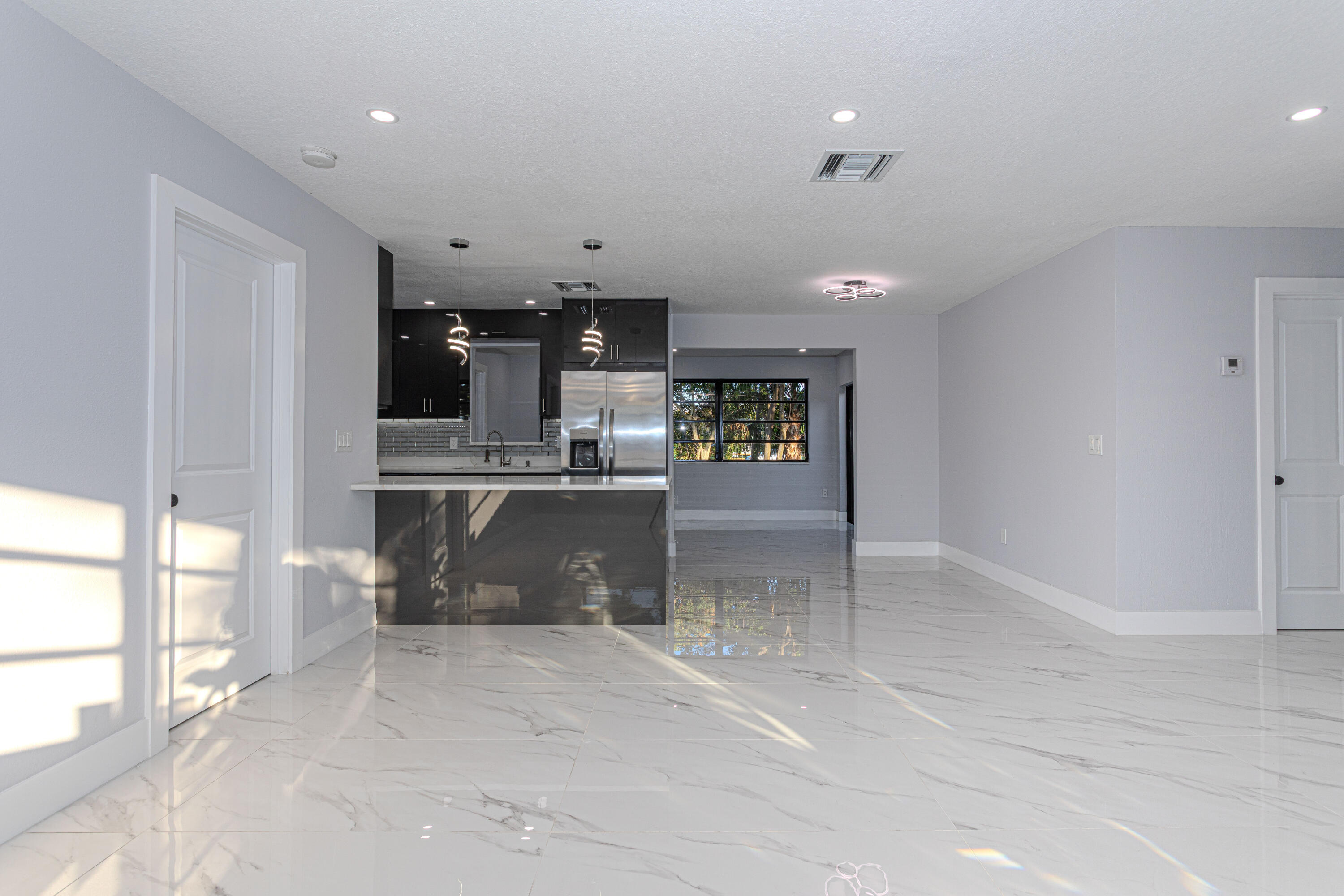 62 Andros Road Palm Springs, FL 33461 - Photo 4 of 41 a view of kitchen with cabinets and window