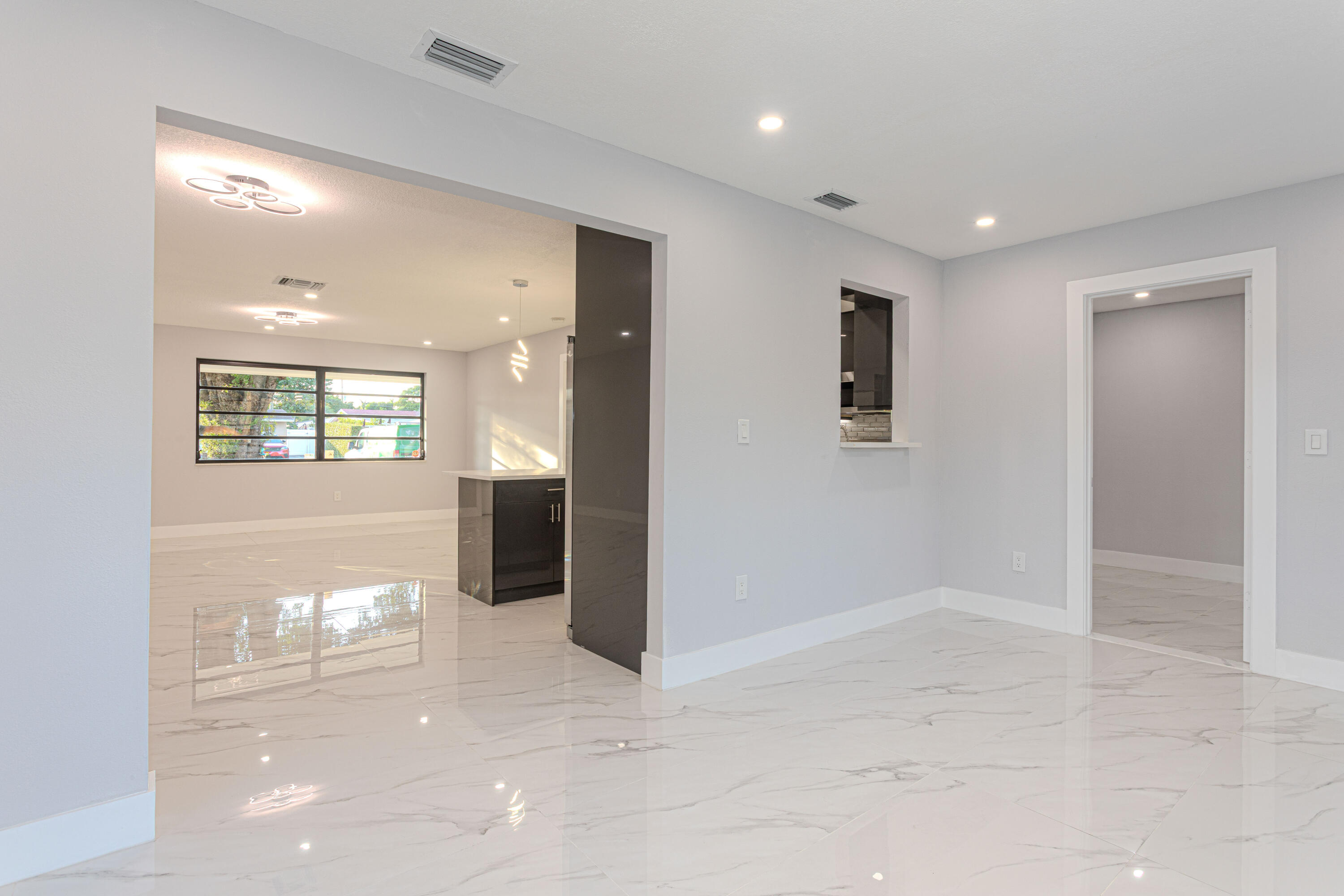 62 Andros Road Palm Springs, FL 33461 - Photo 6 of 41 a view of a hallway with wooden floor and a living room