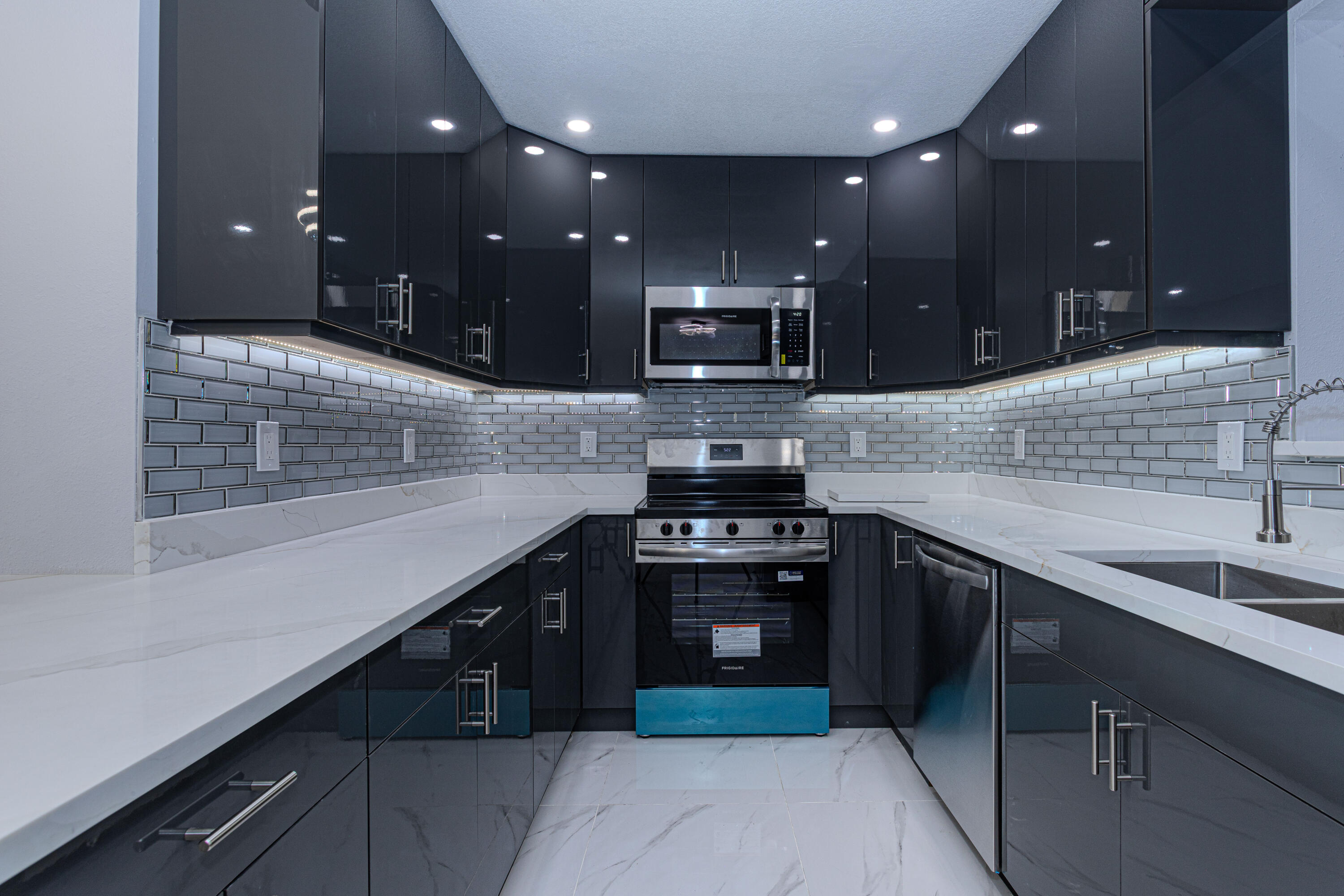 62 Andros Road Palm Springs, FL 33461 - Photo 10 of 41 a open kitchen with stainless steel appliances granite countertop sink stove and granite counter top