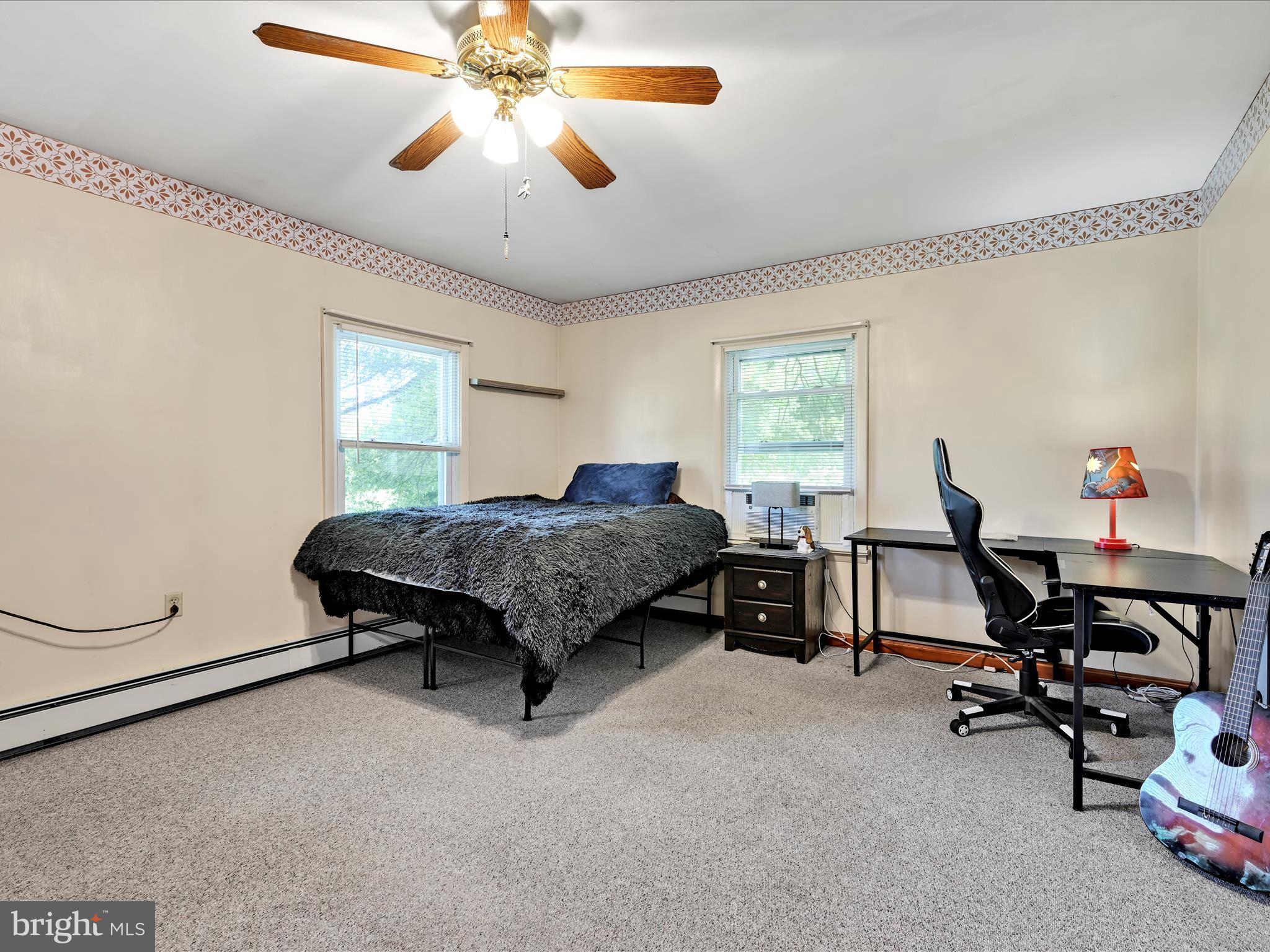 7932 Jonestown Road Harrisburg, PA 17112 - Photo 17 of 79 a bedroom with bed and a chandelier