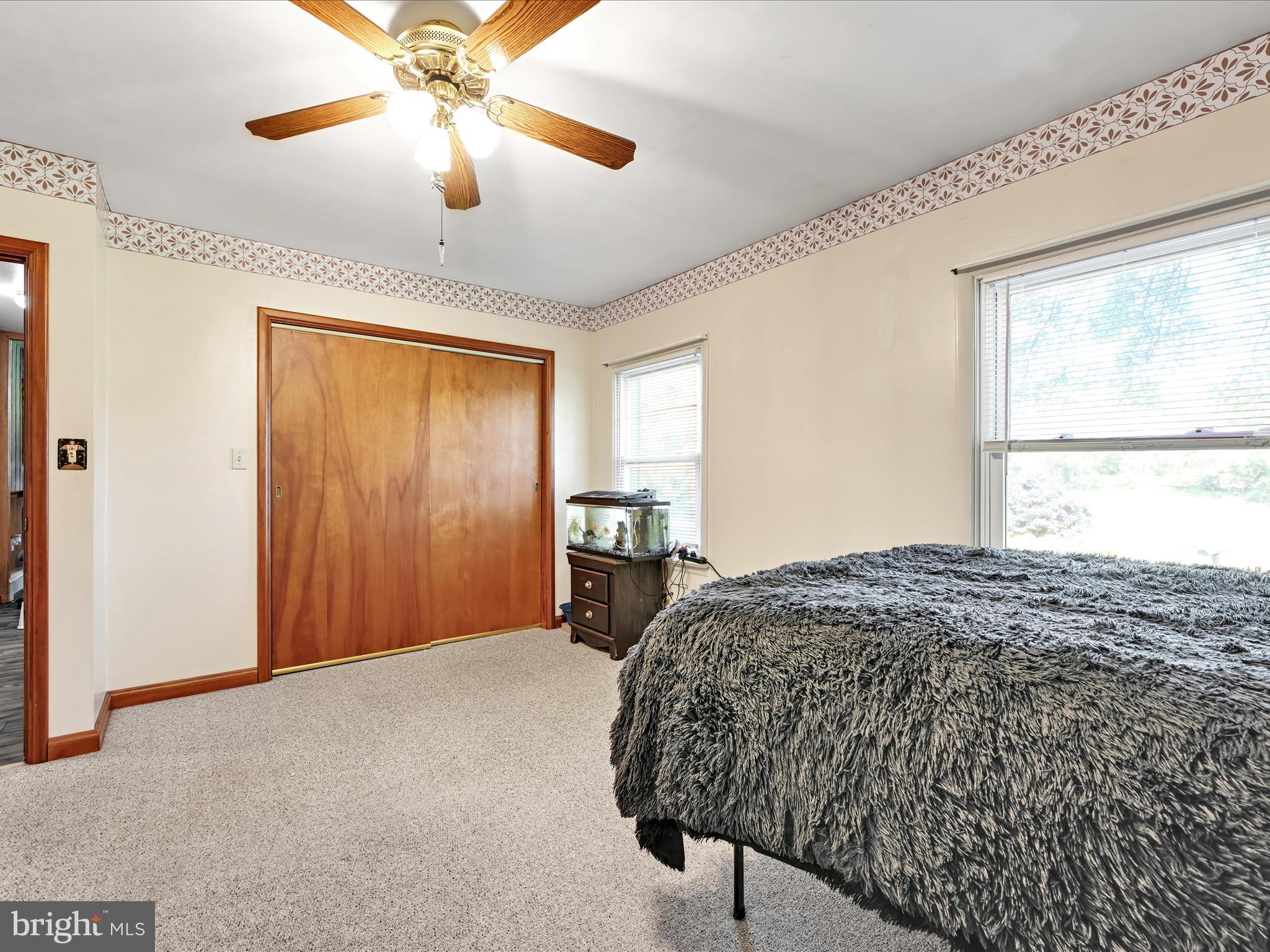 7932 Jonestown Road Harrisburg, PA 17112 - Photo 18 of 79 a bedroom with a bed and a chandelier