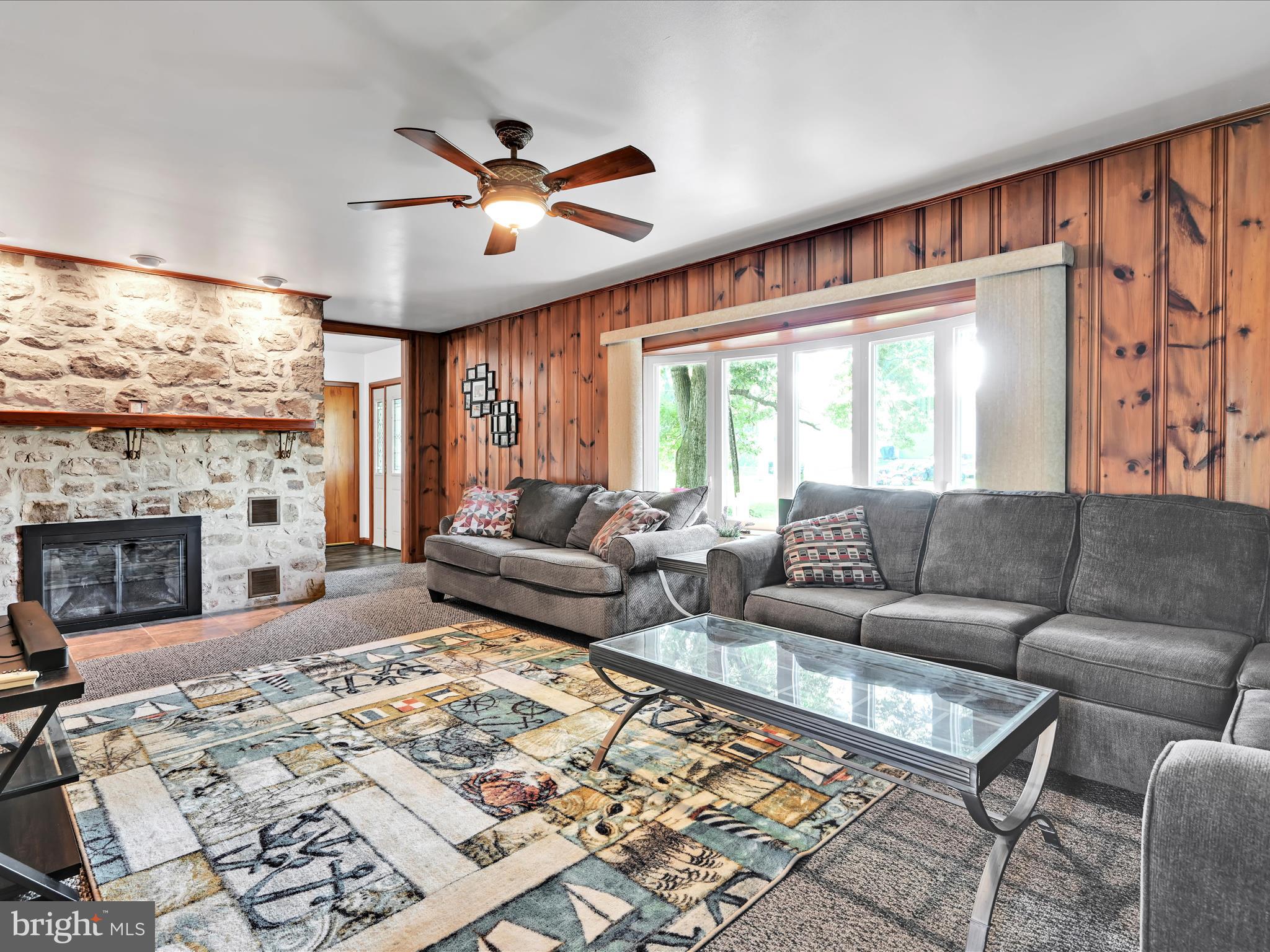 7932 Jonestown Road Harrisburg, PA 17112 - Photo 5 of 79 a living room with furniture a fireplace and a flat screen tv