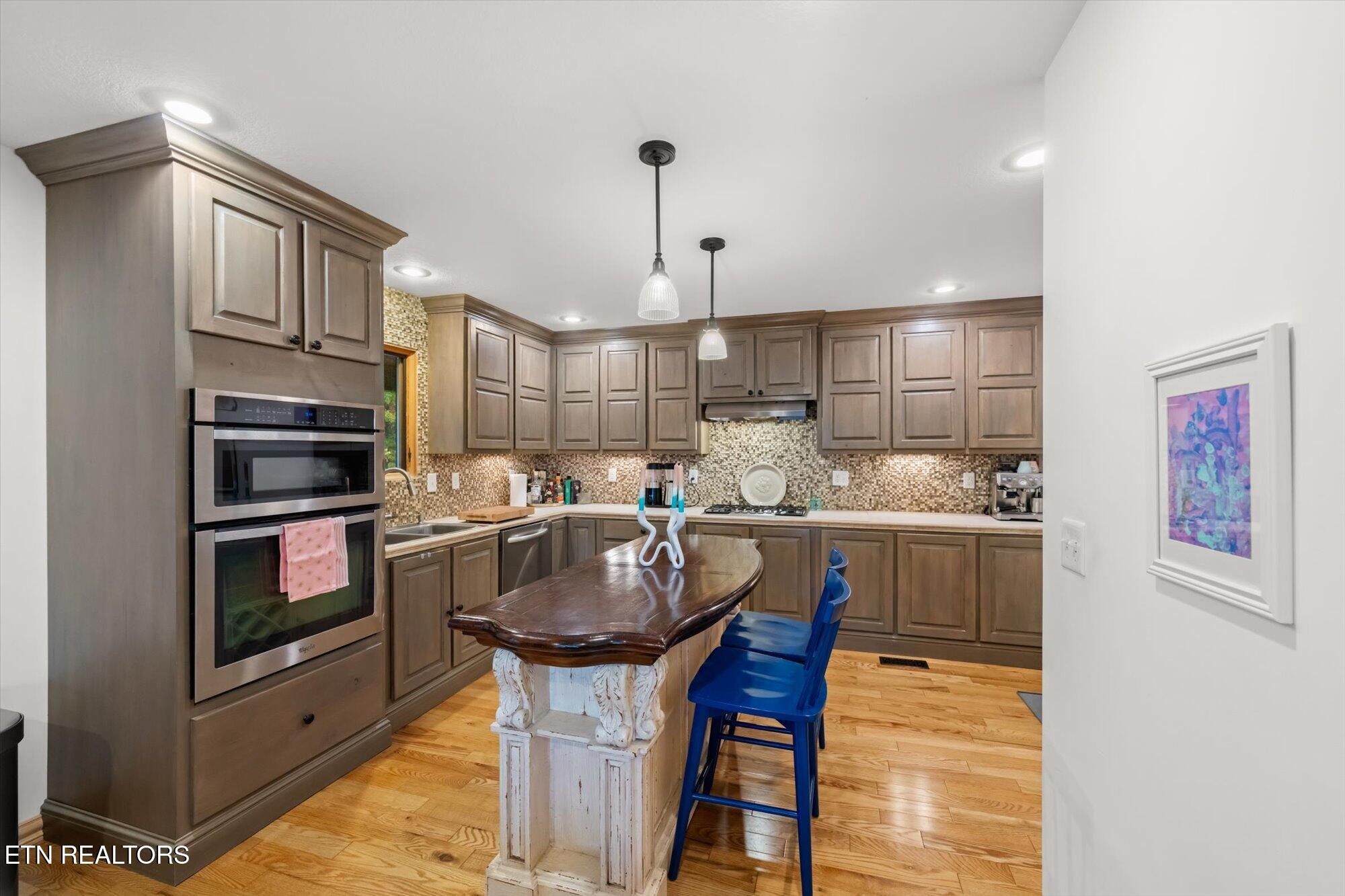 720 East Roddy Road Spring City, TN 37381 - Photo 13 of 58 a kitchen with kitchen island a stove a sink and a refrigerator