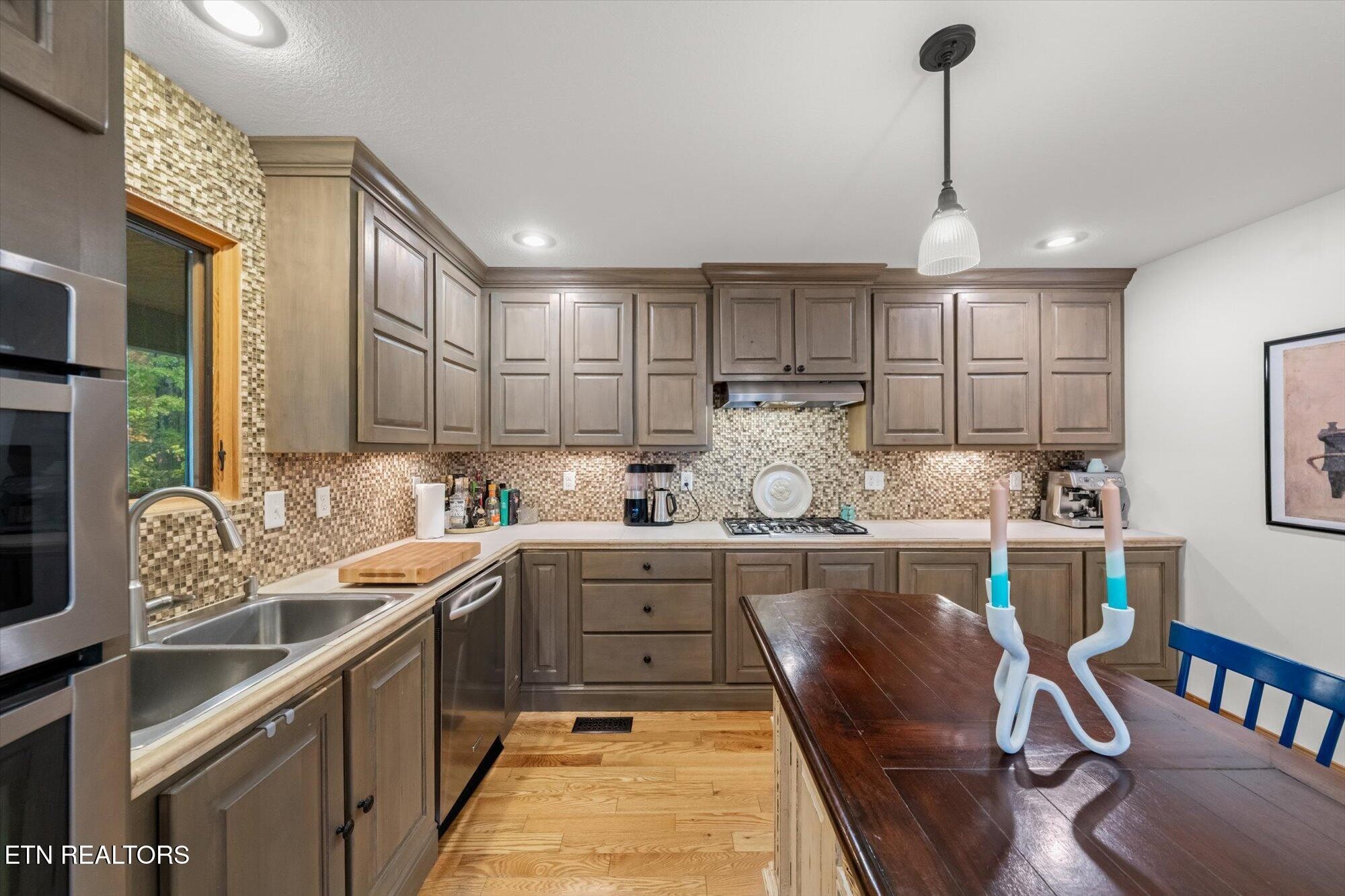 720 East Roddy Road Spring City, TN 37381 - Photo 15 of 58 a kitchen with stainless steel appliances granite countertop sink stove top oven and cabinets
