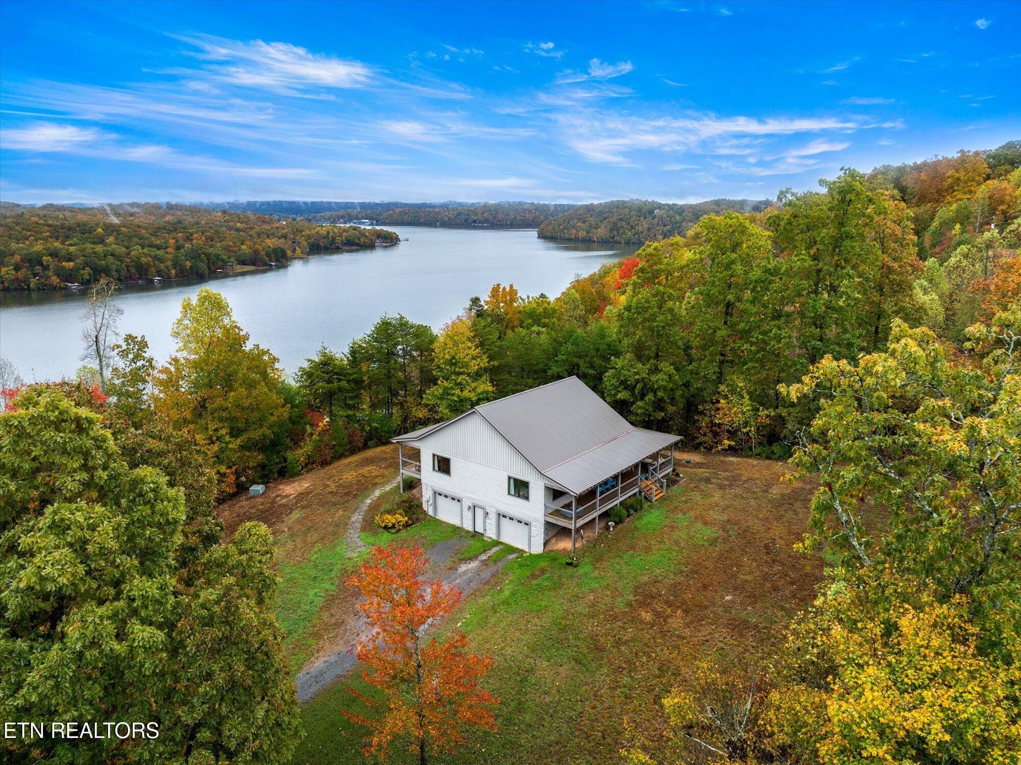 720 East Roddy Road Spring City, TN 37381 - Photo 2 of 58 a view of a lake with a mountain in the background