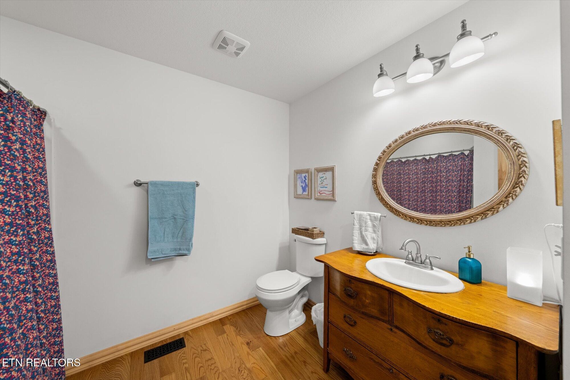 720 East Roddy Road Spring City, TN 37381 - Photo 24 of 58 a bathroom with a toilet a sink and mirror