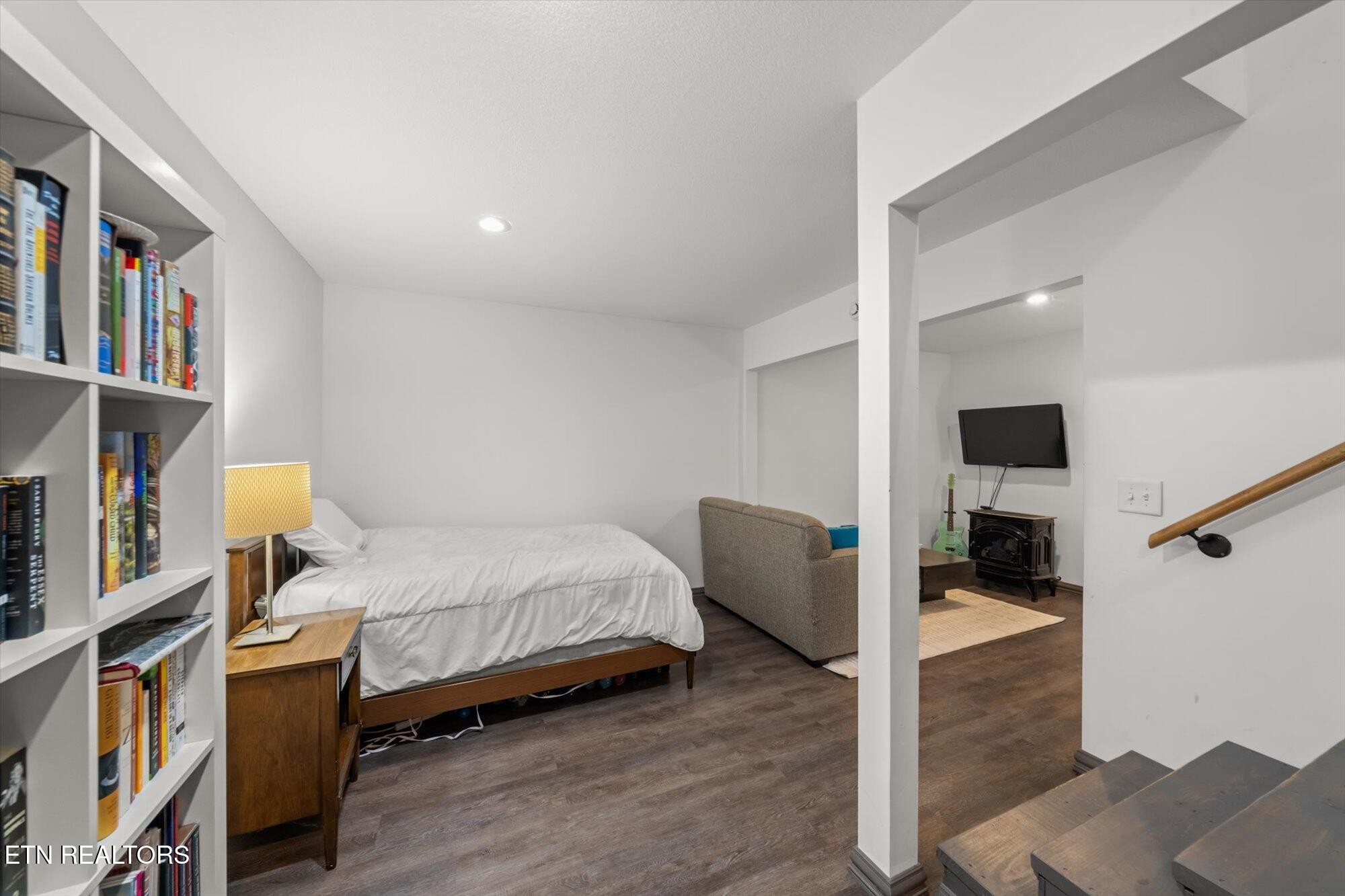 720 East Roddy Road Spring City, TN 37381 - Photo 32 of 58 a bedroom with a bed and a book shelf