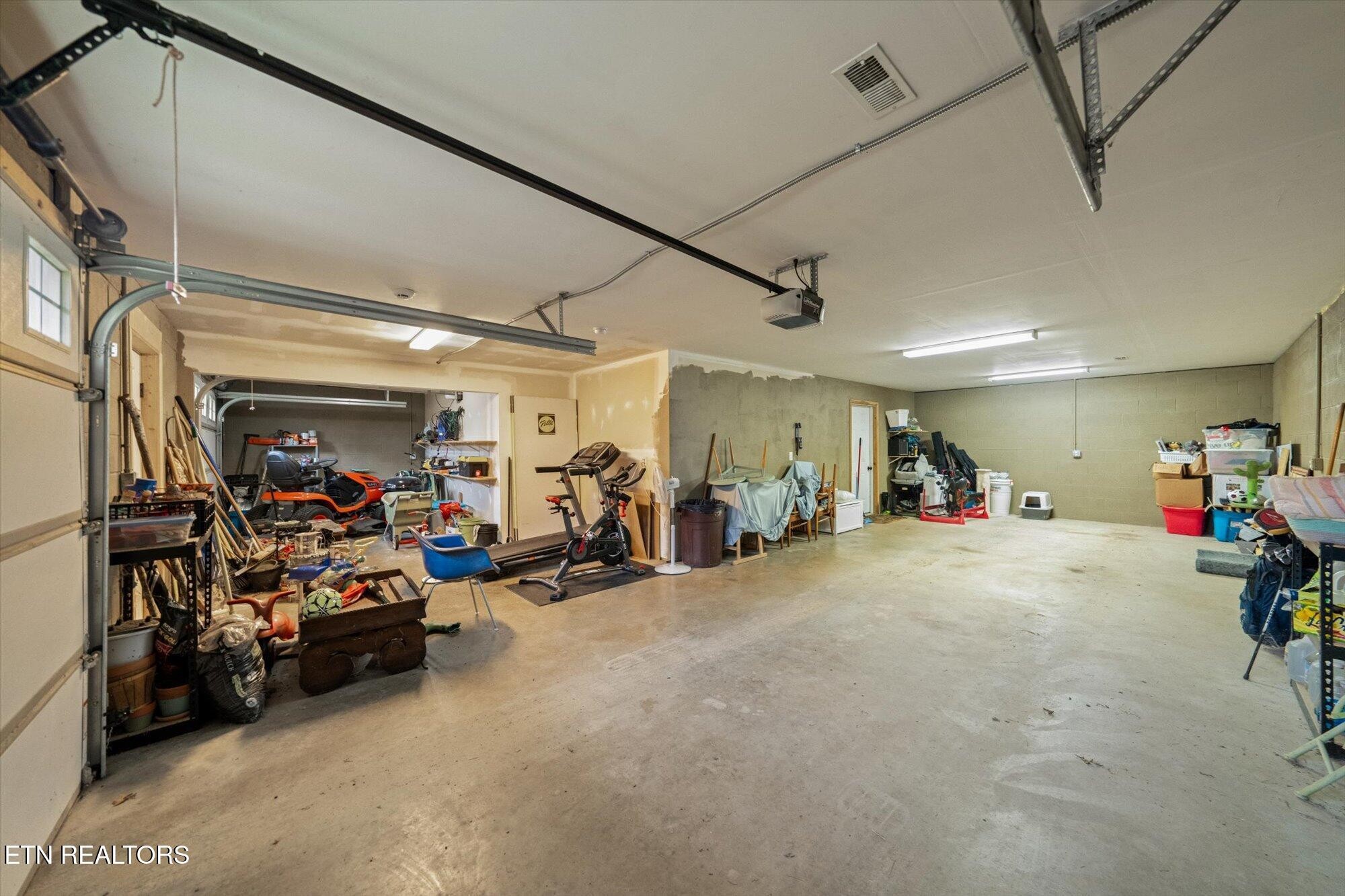 720 East Roddy Road Spring City, TN 37381 - Photo 36 of 58 a view of a garage with a bike and storage