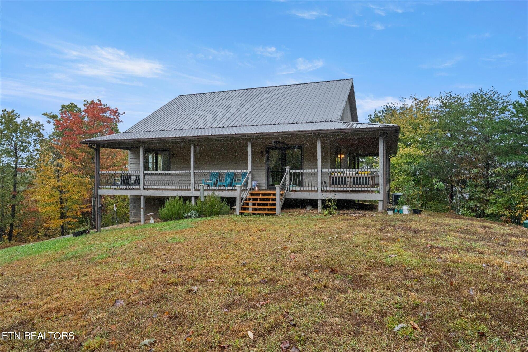 720 East Roddy Road Spring City, TN 37381 - Photo 7 of 58 a view of a house with a porch and a yard