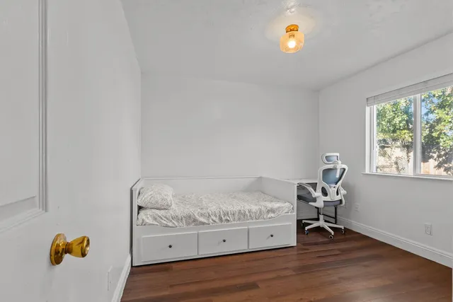 a bedroom with a bed and a window