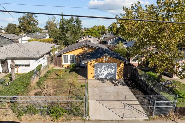 an aerial view of residential houses with outdoor space