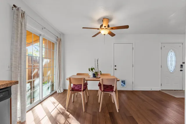 a view of a dining room with furniture window and wooden floor
