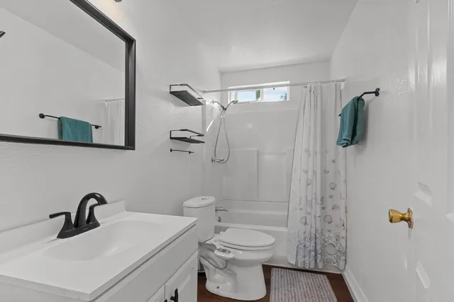 a bathroom with a sink toilet and shower