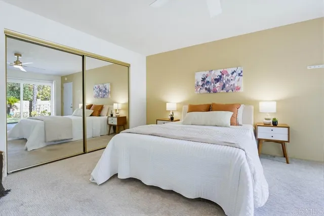 a bedroom with a bed and a painting on the wall