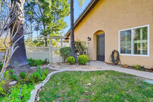 a view of a backyard with plants and patio