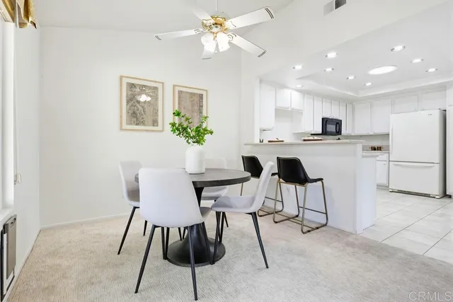 a kitchen with granite countertop cabinets and white appliances