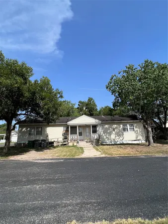 a view of house with swimming pool and a yard