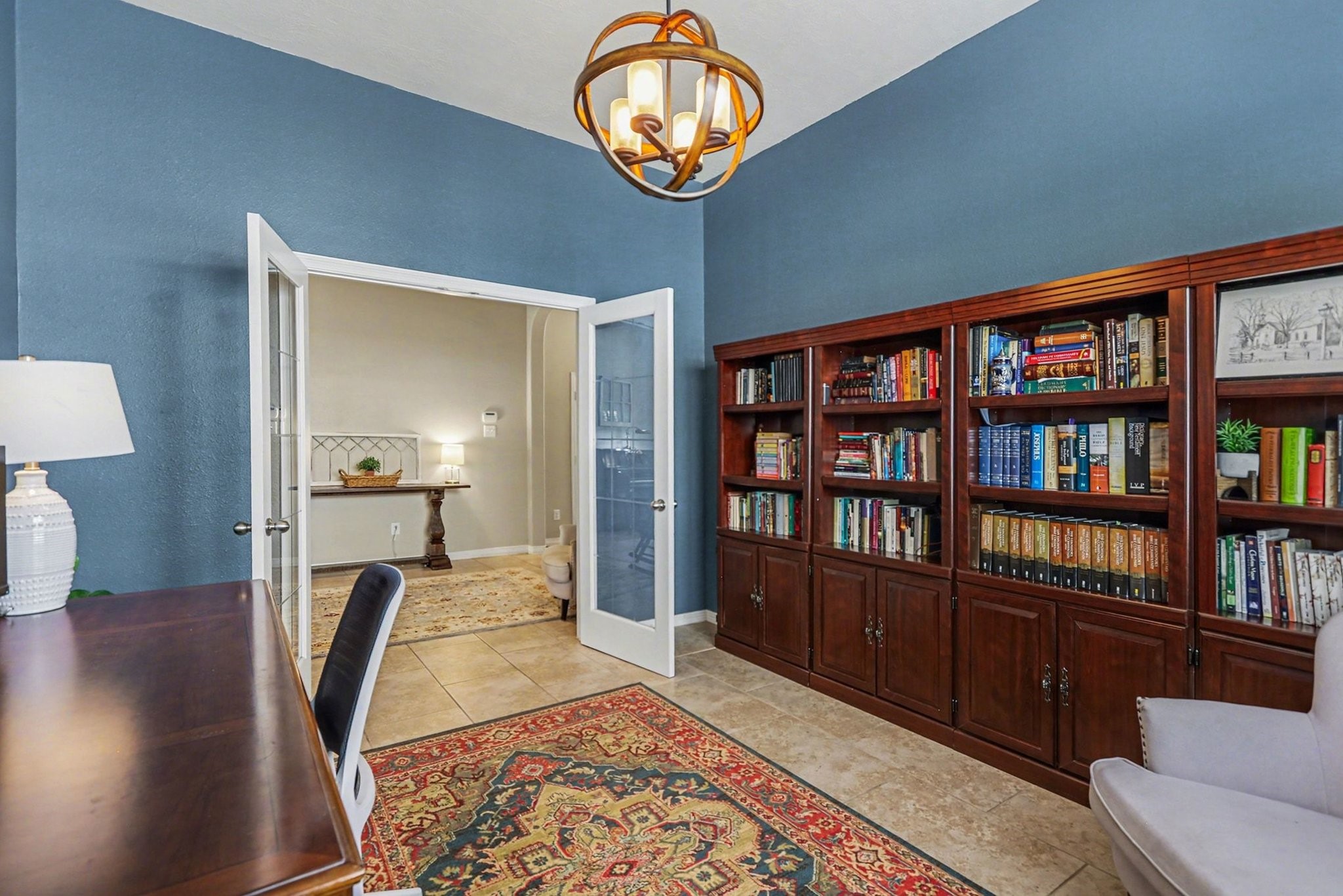 27006 Cliff Pointe Lane Katy, TX 77494 - Photo 15 of 34 Private home office with French doors, rich built-in shelving, and designer lighting—an ideal space for working from home or a quiet retreat.