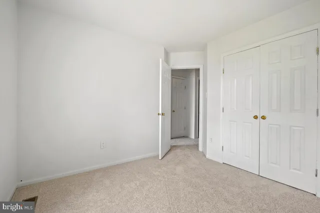 an empty room with closet area