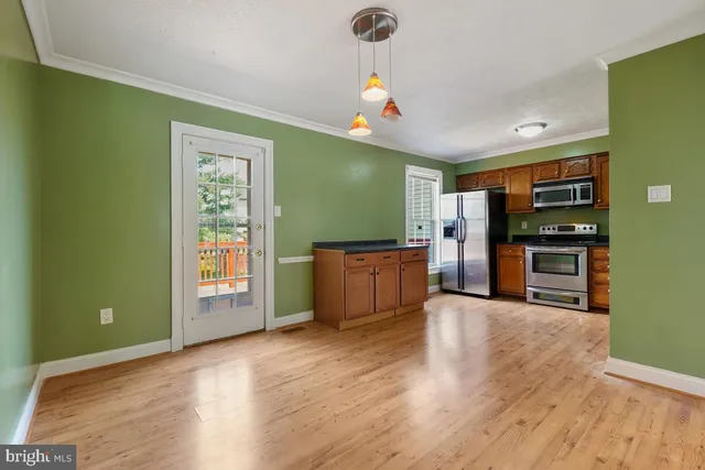 a open kitchen with cabinets a sink and appliances
