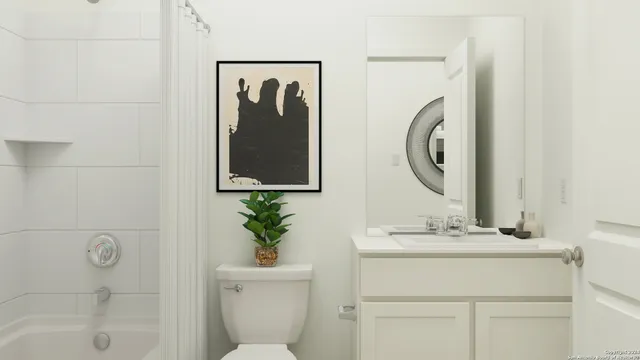 a bathroom with a sink mirror and toilet
