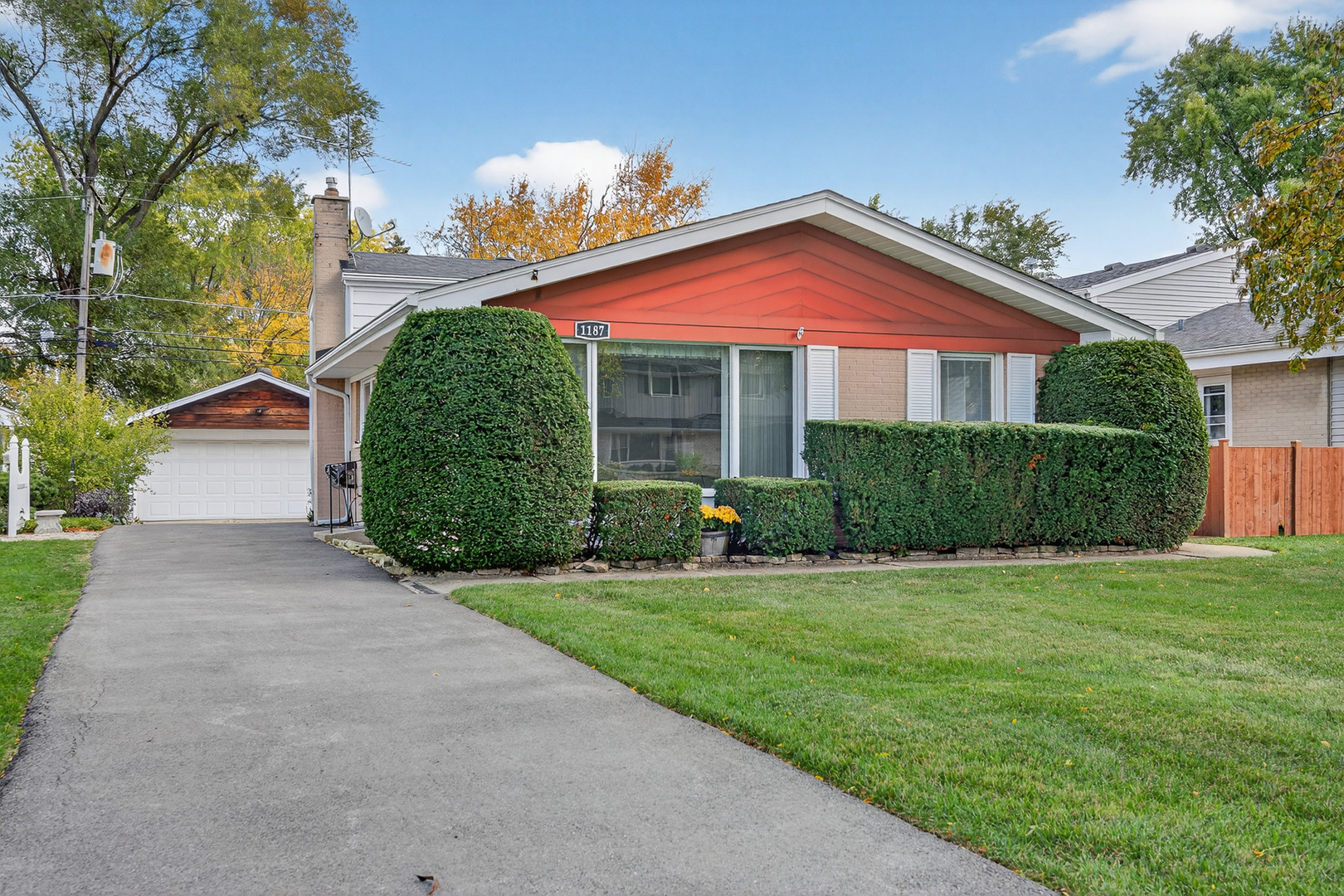 a view of a house with a yard and potted plants