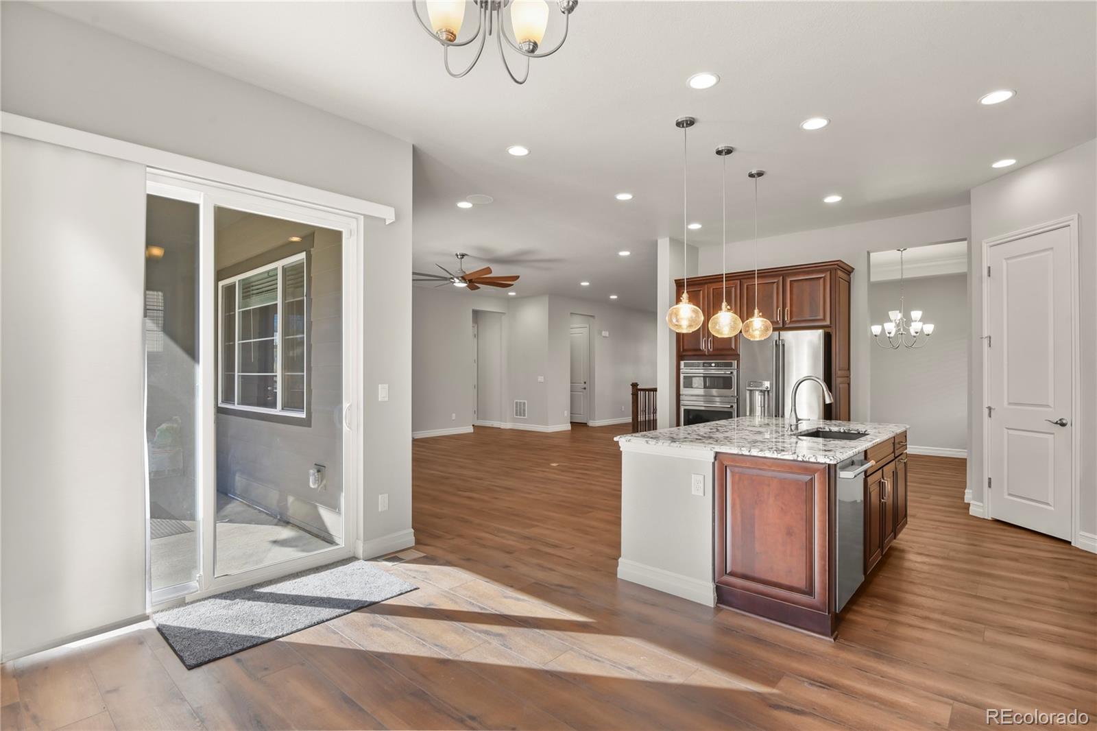 12938 Bridge View Lane Parker, CO 80134 - Photo 13 of 47 a kitchen with stainless steel appliances granite countertop a stove and a refrigerator