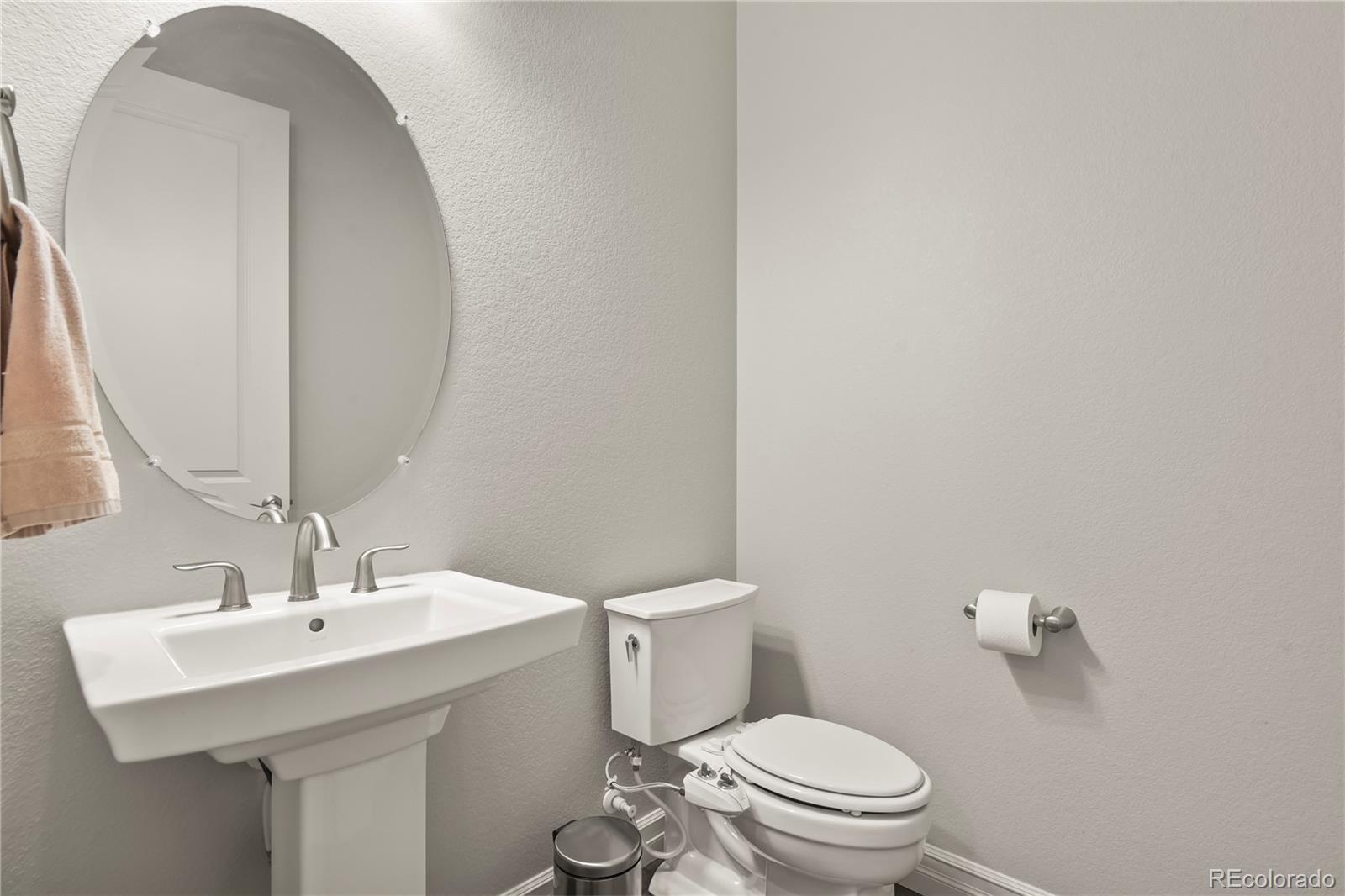 12938 Bridge View Lane Parker, CO 80134 - Photo 26 of 47 a bathroom with a sink a toilet and a mirror