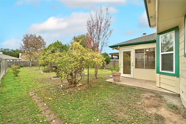 a view of a house with backyard and sitting area