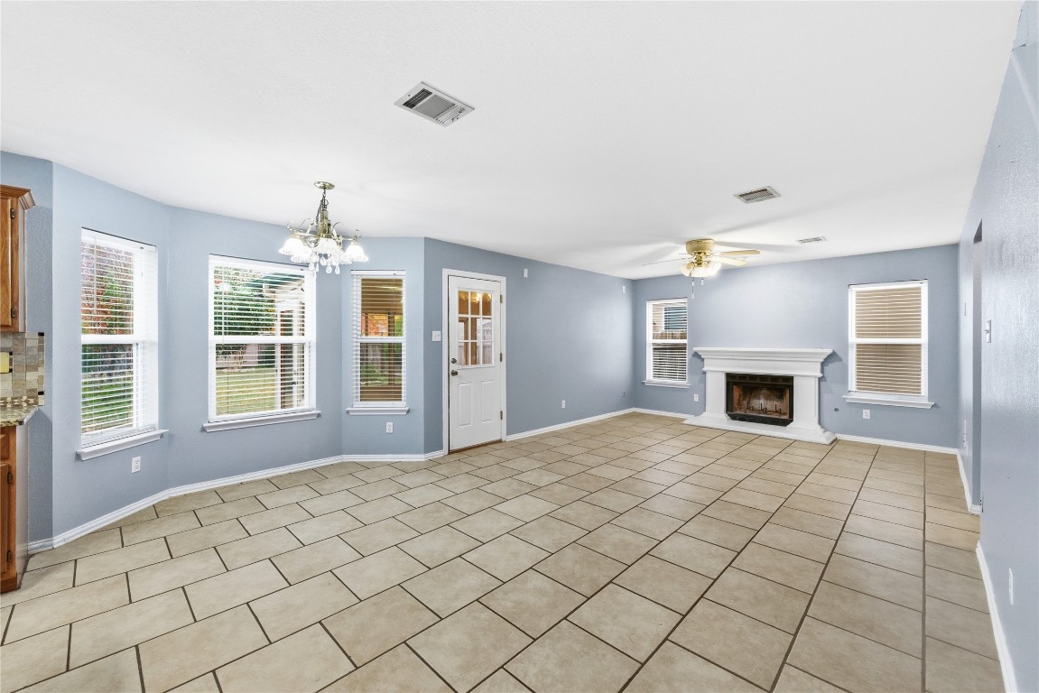 910 Kirtomy Loop Pflugerville, TX 78660 - Photo 18 of 37 a view of an empty room with a fireplace and a window