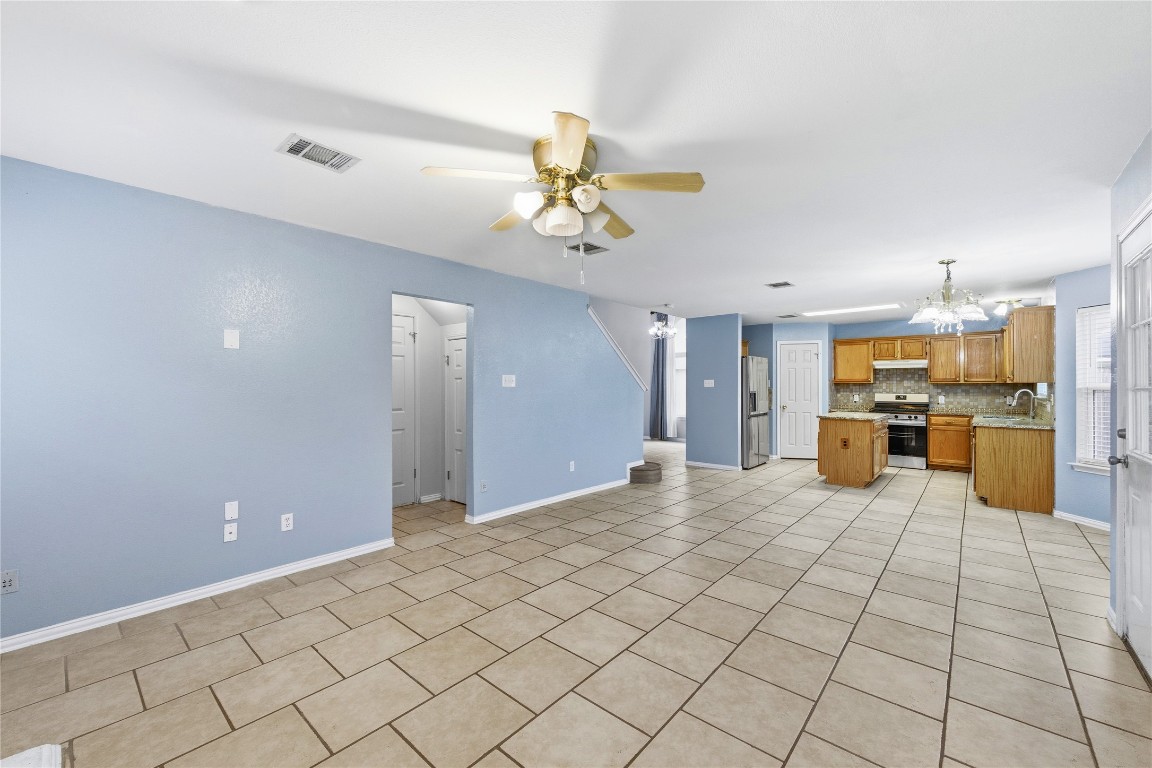 910 Kirtomy Loop Pflugerville, TX 78660 - Photo 19 of 37 a view of a kitchen with a refrigerator and a stove top oven