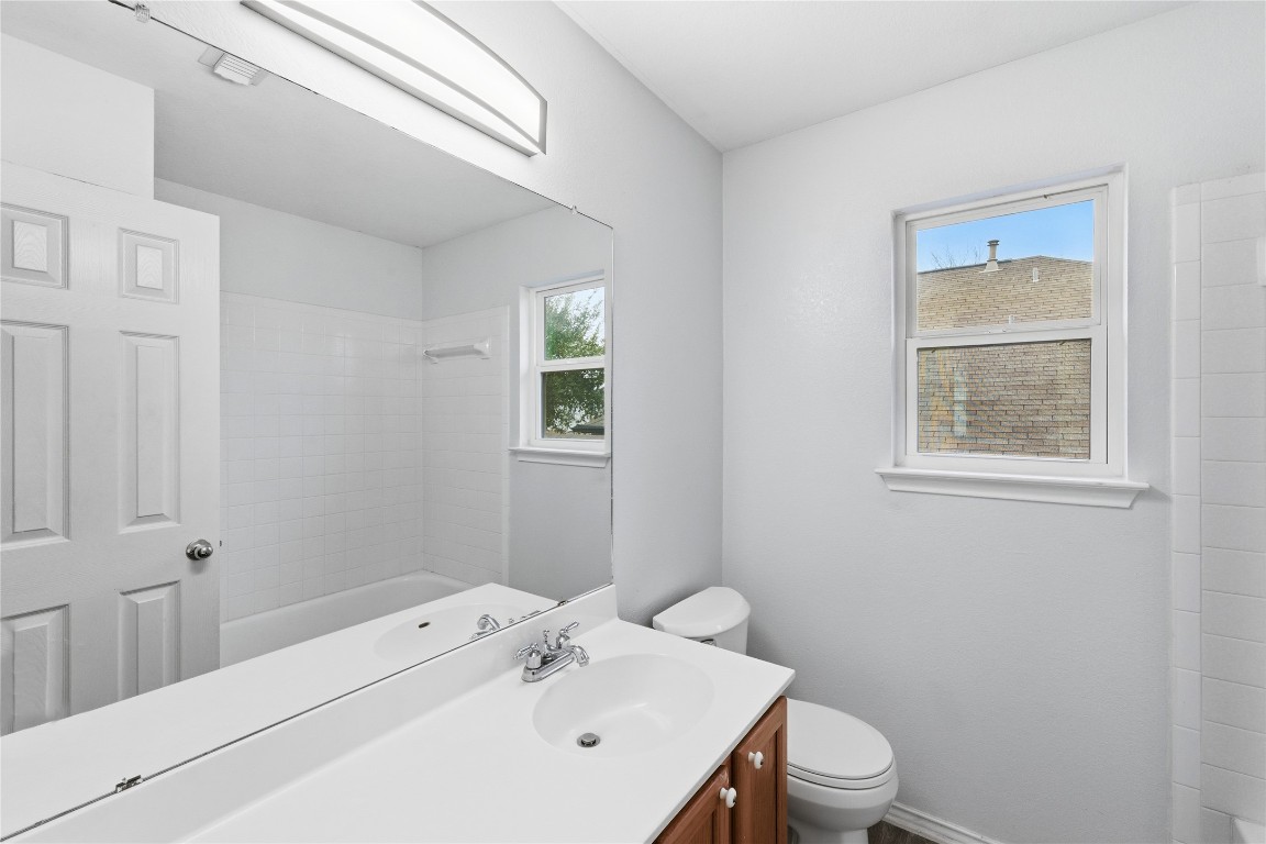 910 Kirtomy Loop Pflugerville, TX 78660 - Photo 23 of 37 a bathroom with a sink a toilet and window