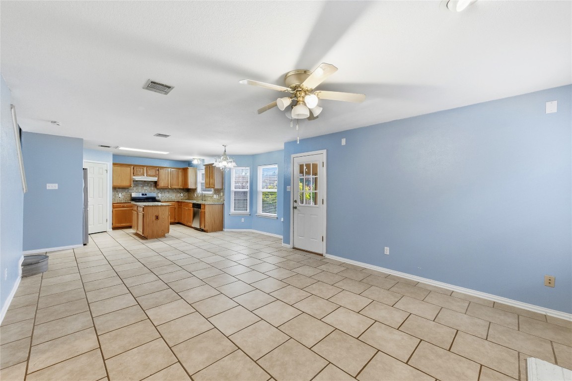 910 Kirtomy Loop Pflugerville, TX 78660 - Photo 28 of 37 a large bedroom with a large bed chandelier and closet