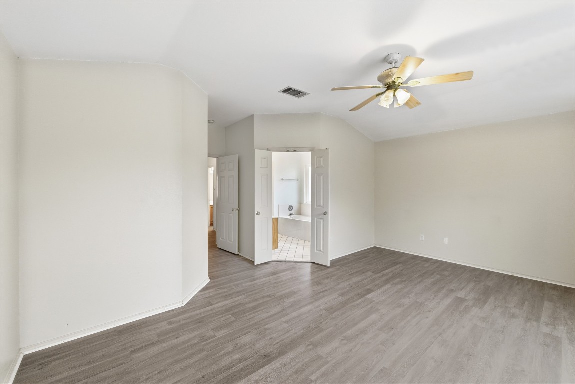 910 Kirtomy Loop Pflugerville, TX 78660 - Photo 32 of 37 a view of an empty room with wooden floor