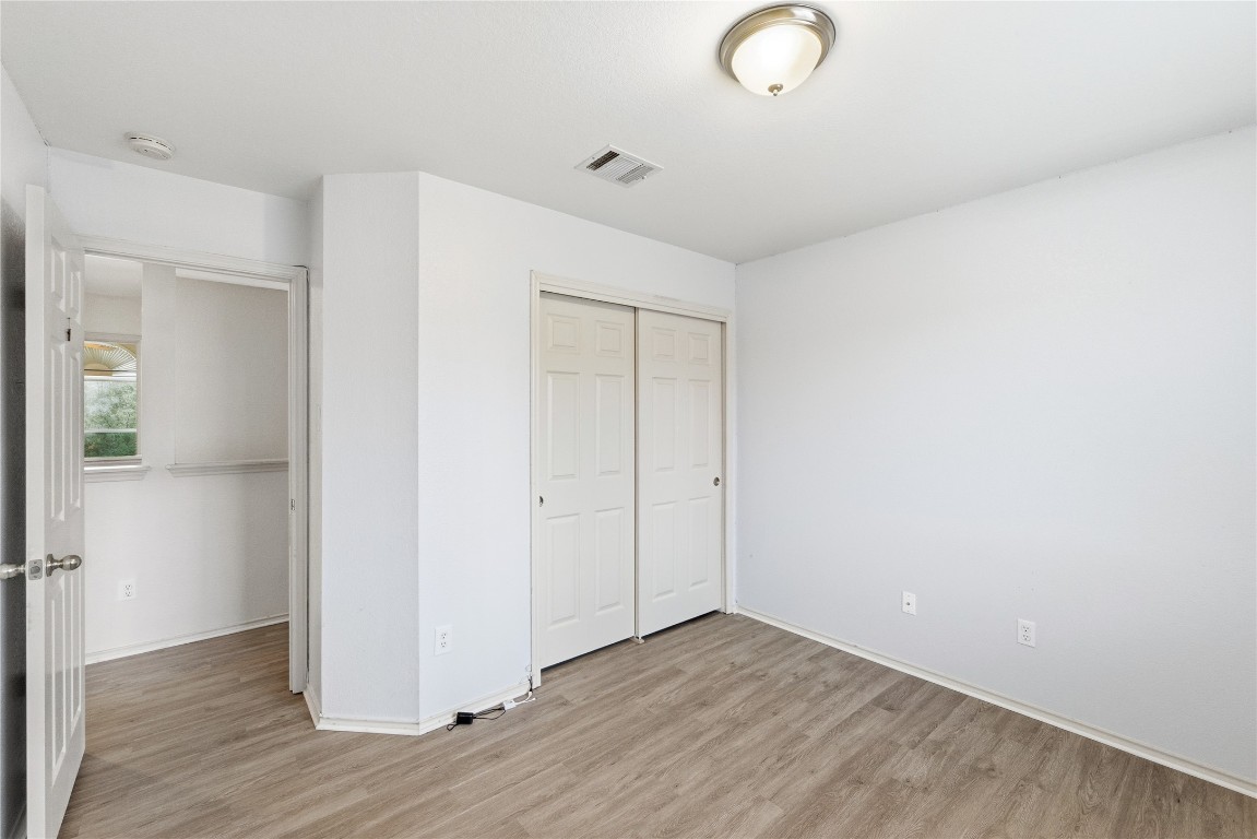 910 Kirtomy Loop Pflugerville, TX 78660 - Photo 10 of 37 a view of an empty room with wooden floor