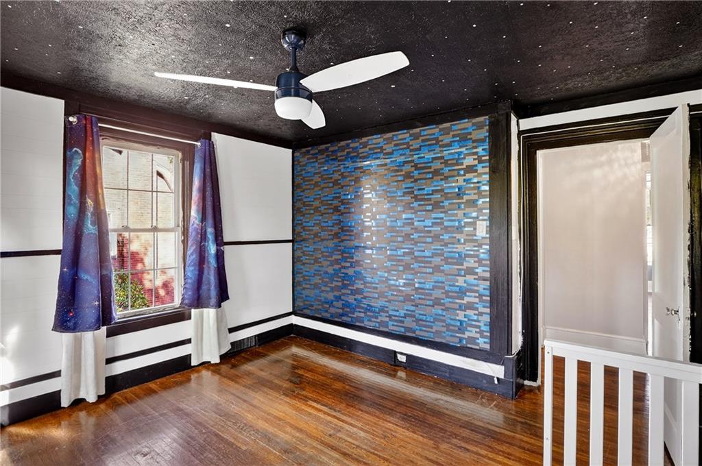 1702 3rd Avenue New Brighton, PA 15066 - Photo 17 of 40 a view of an empty room with a window and wooden floor