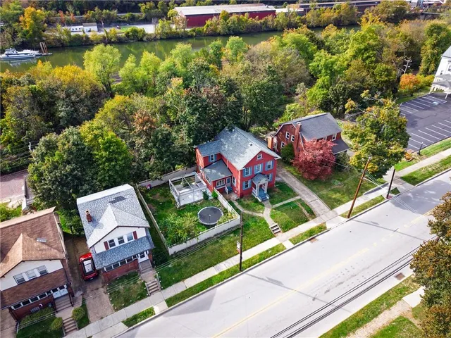 an aerial view of a houses with a yard
