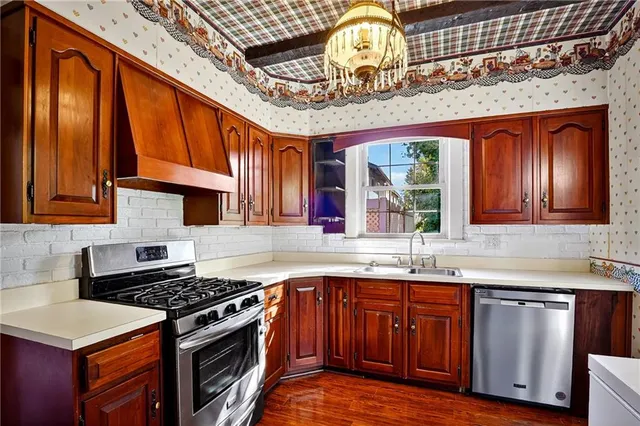 a kitchen with stainless steel appliances granite countertop a stove and a sink