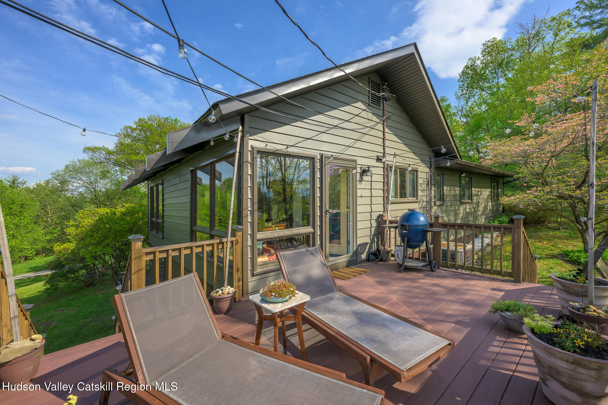 29 Edgemere Hill Road Catskill, NY 12414 - Photo 5 of 38 a view of a patio with table and chairs potted plants with wooden floor and fence