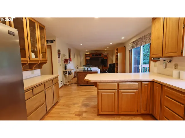 a kitchen with stainless steel appliances kitchen island granite countertop a sink and cabinets