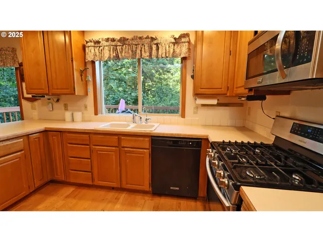 a kitchen with a sink window and cabinets