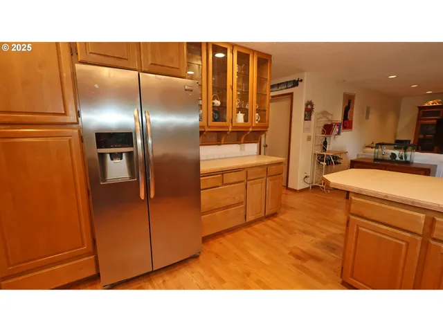a kitchen with stainless steel appliances refrigerator and microwave