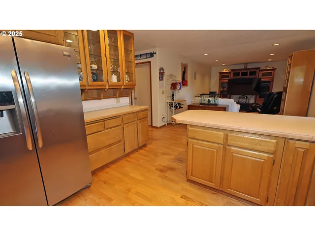 a kitchen with stainless steel appliances kitchen island granite countertop a refrigerator a stove and a sink